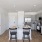 Kitchen with Island and Smart Stainless Steel Appliances and Bar Stools
