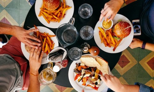 Dining people eating inside a restaurant