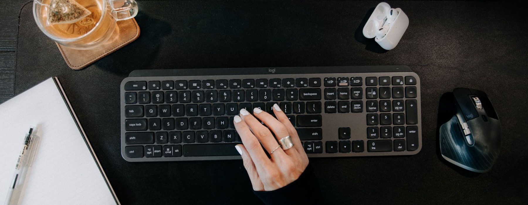a woman's hand typing on a keyboard